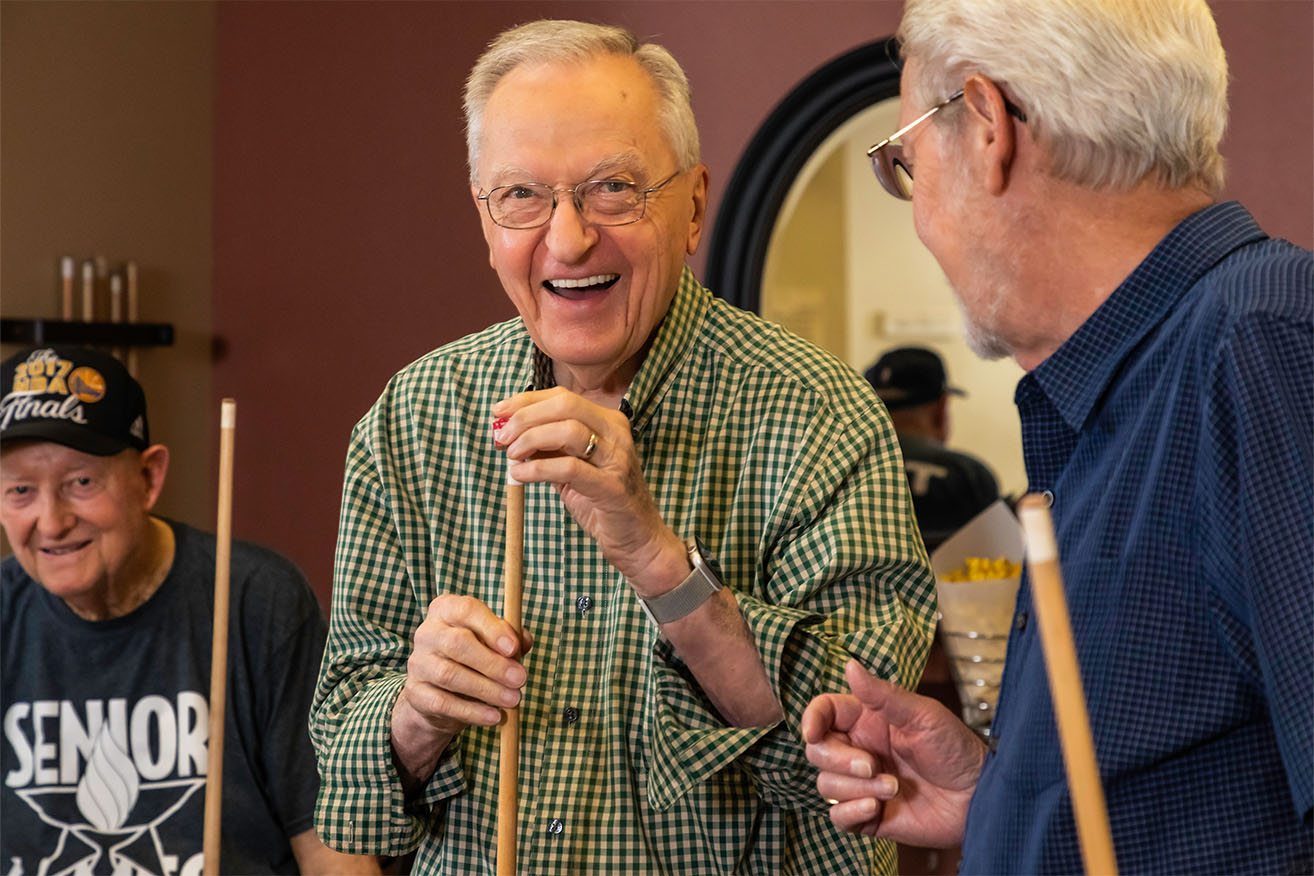 Three senior men playing pool 